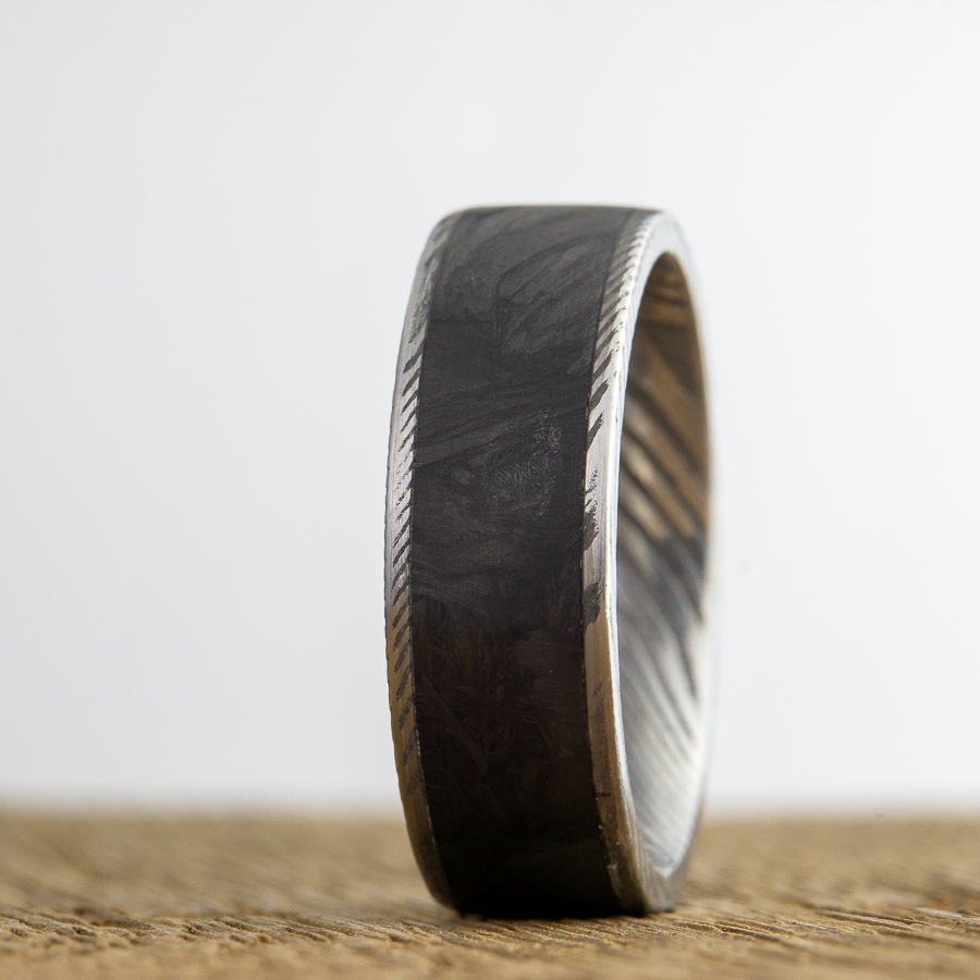 Damascus steel ring with forged carbon fiber