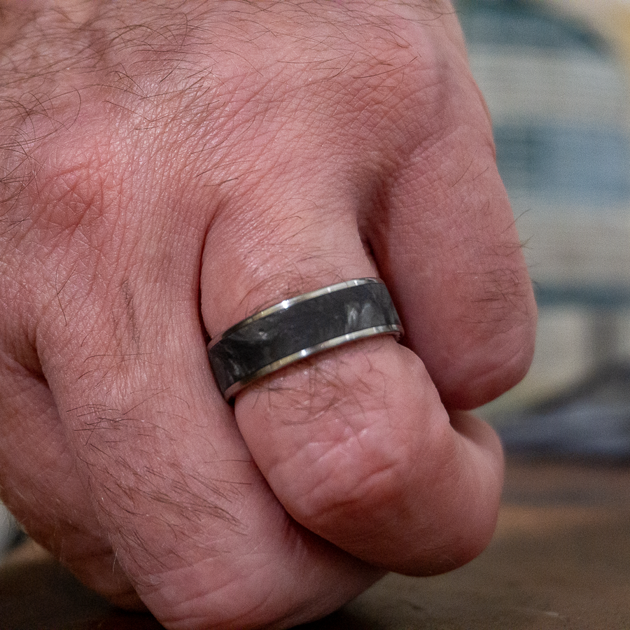 titanium forged carbon fiber ring on finger