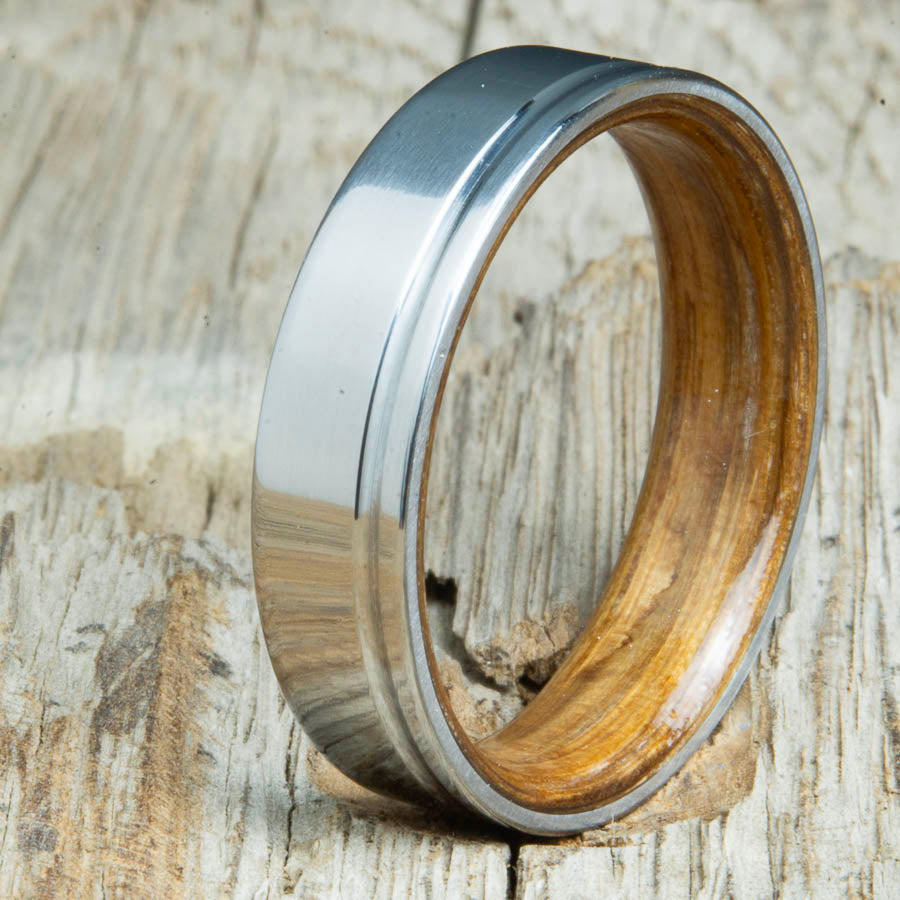 classic grooved titanium ring with whiskey barrel wood interior. Custom whiskey barrel wedding bands made by Peacefield Titanium